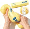 Jumbo butter squishy squeezed between hands with butter-stick prop
